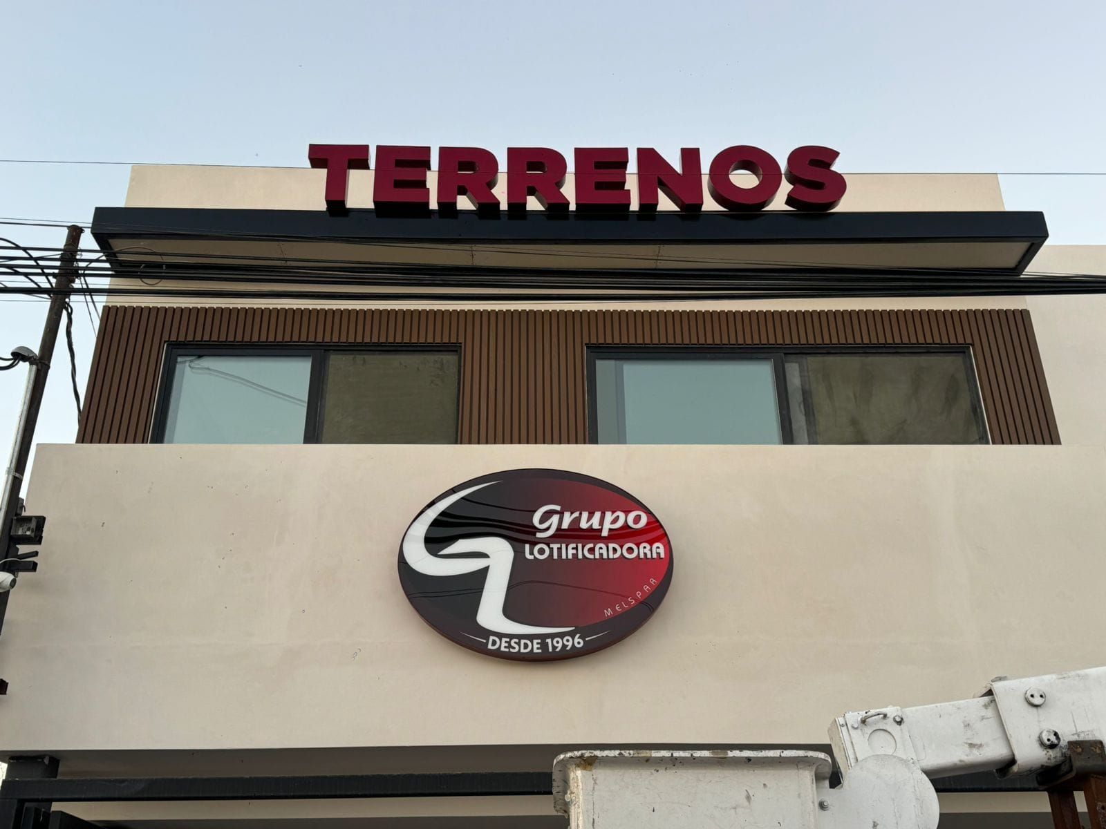 Las letras de "TERRENOS" ya montadas en la azotea junto a la charola circular de Grupo Lotificadora.